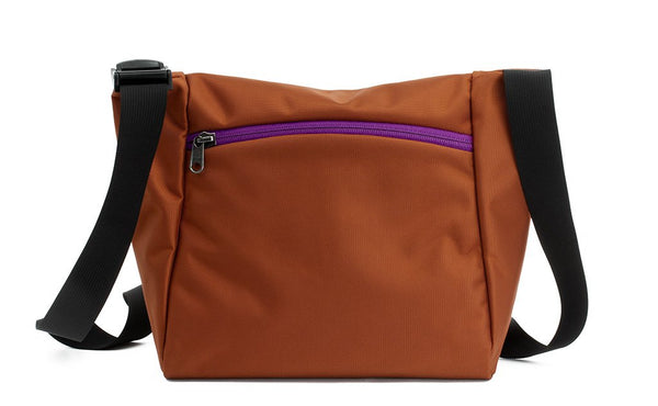 Reverse shot of an Icon in Burnt Orange 525 Ballistic with Ultraviolet (purple) zippers.